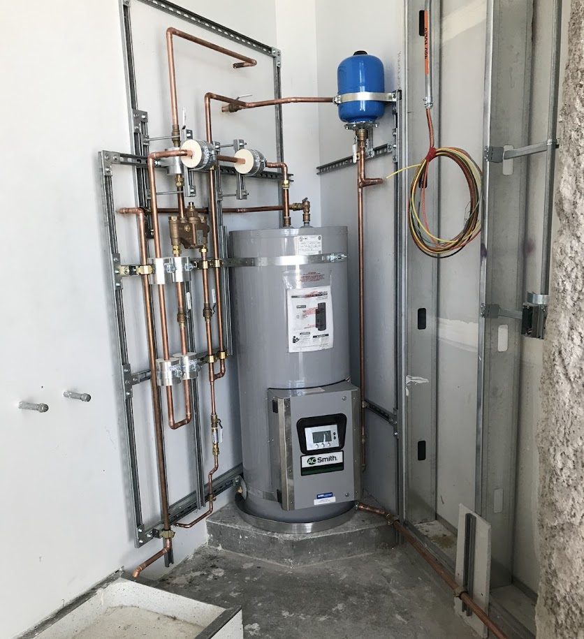 Commercial A.O. Smith water heater installation with copper piping and expansion tank